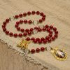 Handmade Rosary with Cinnabar Beads and Jesus Medal – A Divine Emblem of Faith's Devotion